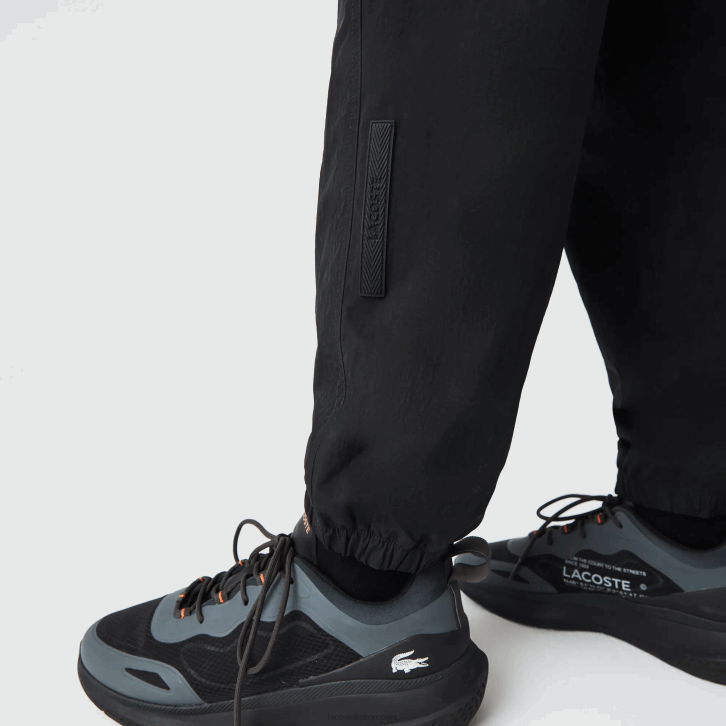 homens Lacoste preto amarelo n07 Calça esportiva com blocos de cores de ajuste regular Heritage 08D01110